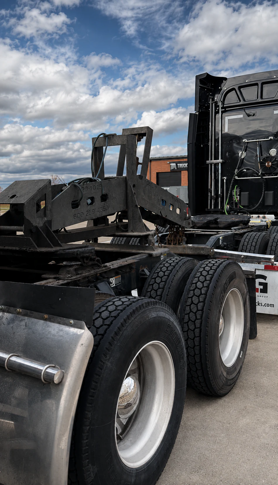 Heavy-duty truck chassis with a steel towing frame and dual rear tires at Big Truck & Trailer Repair in Park City, Illinois